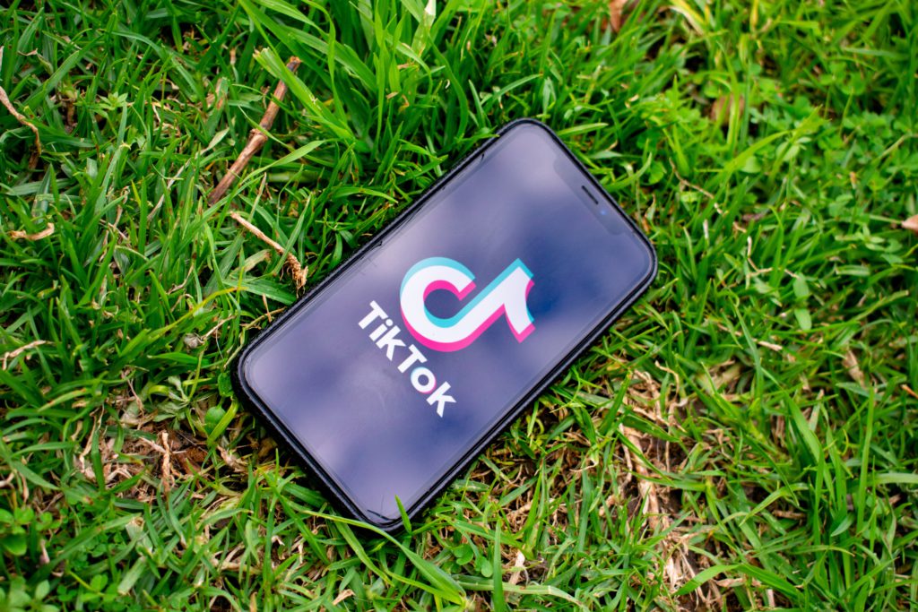 Phone with TikTok app laying in grass