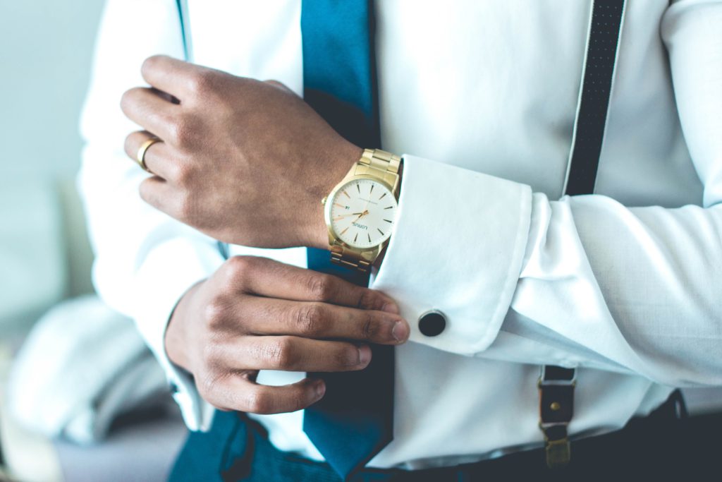 Man in suit with a luxury watch around the wrist