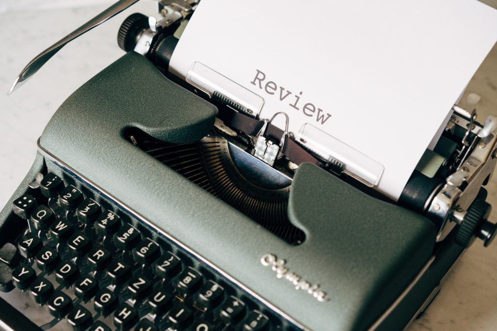 A typewriter with the word "Review" written on a paper